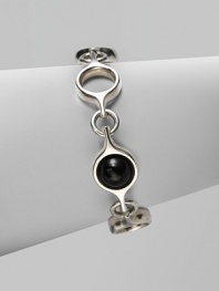 An unique and modern design featuring black agate spherical inset links and sterling silver circular links. Black agateSterling silverToggle closureLength, about 7½Imported 