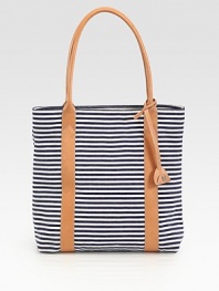 A canvas design with nautical-inspired stripes and chic leather handles. Double leather handles, 9 dropSnap closureThree inside pocketsFully linedCottonImported