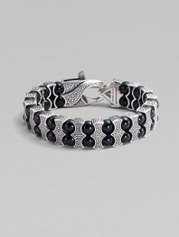 Architectural drama defines this bold bracelet, constructed of double rows of black onyx beads held by scalloped pillars of sterling silver. Black onyx Sterling silver Length, about 8¾ Lobster clasp Imported