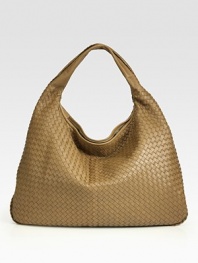 Utter simplicity in buttery woven leather in a classic hobo shape. Single shoulder strap, 5 drop Braid trim Top zip closure Inside zip pocket Suede lining 22W X 15H X 2½D Made in Italy 