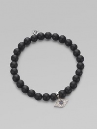 A protective symbol in many cultures, an evil eye charm of 14k white gold is richly set with diamonds and sapphires, and hangs from a stretchy strand of matte black onyx beads. Diamonds, 0.07 tcw Black onyx 14k white gold Diameter, about 2 (unstretched) Charm length, about ½ Imported