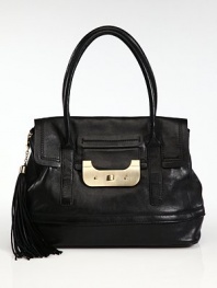 Sumptuous leather in a roomy top-handle carryall, finished with polished goldtone hardware and an oversized tassel.Double top handles, 7 dropTurnlock flap closureOne outside open pocketProtective metal feetOne inside zip pocketCenter zip compartmentThree inside open pocketsCotton lining14¾W X 11H X 6½DImported
