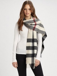 A beautiful cashmere style with an signature print and fringe details. CashmereAbout 14 X 79Dry cleanImported 