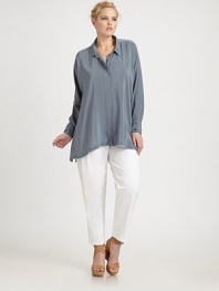 Offering quintessential everyday luxury, this crepe de chine button-front design has a hidden pocket and a distinctly charming asymmetrical hem. Collar neckLong sleevesButton cuffsButton frontAsymmetrical hemAbout 30 from shoulder to hemSilkDry cleanImported
