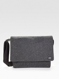 Sturdy and sleek in durable, water resistant waxed wool, detailed with leather trim and custom die-cast black hardware.Adjustable shoulder strapFlap closureLaptop interior pocket with tab closureOrganizing pocketsInterior zipper pocketsCotton liningWaxed wool exterior14 X 14 X 3Imported