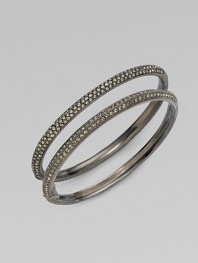 EXCLUSIVELY AT SAKS. Double rows of radiant crystals with a subtle dark cast are hand-set within an antiqued hinged bangle. Crystal Antiqued silvertone Diameter, about 2¼ Push-lock clasp Imported