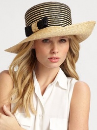 A jaunty, asymmetrical brim is offset by a graphic striped crown and attached bow detail.StrawBrim, about 5 wideMade in Italy of imported fabric