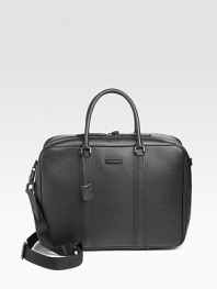 A sophisticated case crafted in granulated leather with iconic check lining and straps inside to hold your laptop in place. Zip closure with lock Top handles Adjustable, detachable shoulder strap Interior zip, slip pockets Fully lined 18W X 13H X 6D Made in Italy 
