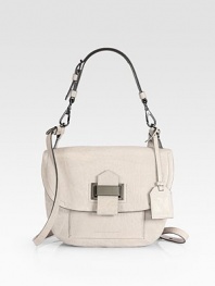 A trim, tailored shoulder style in tumbled leather with a front flap and a bold tab strap.Detachable top handle, 7 drop Detachable, adjustable shoulder strap, 24 drop Magnetic snap flap close Front open pocket under flap Back double open pockets One inside zip pocket One inside open pocket Cotton lining 9W X 7½H X 3D Imported