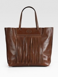 An easy shape of lustrous leather, topped off with fringe detailing for a boost of style. Double top handles, 7 dropSnap top closureOne inside open pocketFully lined16W X 12H X 5DMade in Italy