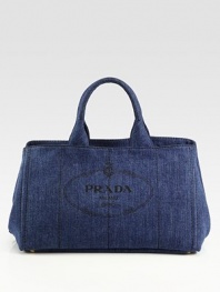 Chic denim style with heritage Prada logo print and stitch detail.Double top handles, 6 drop Open top Protective metal feet Two inside zip pockets Two inside open pockets 16W X 10H X 10D Made in Italy