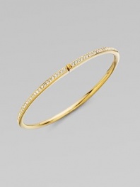 EXCLUSIVELY AT SAKS. A row of shimmering channel-set crystals within a glowing, golden hinged bangle. Crystal 18k goldplated Diameter, about 2¼ Push-lock clasp Imported