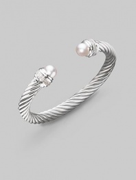 From the Silver Ice Collection. A signature Yurman cable of sterling silver, richly enhanced by bands of pavé diamonds encircling lustrous white freshwater pearl end caps. Diamonds, 0.48 tcw White freshwater pearls Sterling silver Cable, 7mm Diameter, about 2¼ Made in USA