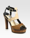Patent leather and leather colorblock design with a t-strap and an earthy cork platform. Wooden heel, 5 (125mm)Cork platform, 1 (25mm)Compares to a 4 heel (100mm)Patent leather and leather upperLeather liningRubber solePadded insoleMade in ItalyOUR FIT MODEL RECOMMENDS ordering true size. 