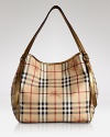 Give your look a classic finish with Burberry's leather-trimmed tote in the brand's iconic check.