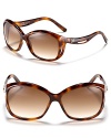 Balenciaga's chic oversized sunglasses feature a curving frame for a unique design.