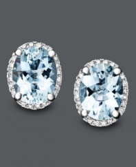 Frost your lobes with sparkling aqua-colored studs. Earrings crafted in 14k white gold feature oval-cut aquamarine gemstones (2-3/4 ct. t.w.) surrounded by a halo of diamond (1/8 ct. t.w.).