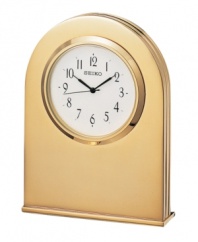 Crafted with beautifully understated modern style, this desktop clock adds elegance to any setting. Goldtone solid brass case. Round white dial with logo and numeral indices. Battery included. Measures approximately 3-3/4 x 2-3/4 x 3/4.