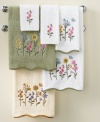 Escape into a garden of plush delights with Avanti's Premier Country Floral hand towel, featuring beautiful embroidery and a scalloped fabric trim on pure Egyptian cotton.