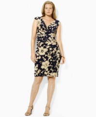A beautiful floral print imparts breezy elegance to this plus size Lauren by Ralph Lauren empire-waist dress, crafted from fluid matte jersey in a ruched silhouette with a chic crossover neckline and cap sleeves.