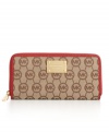 MICHAEL Michael Kors' classic monogram continental gets a fun energy with vibrant contrast leather trim in a variety of hot hues, while the 18K gold logo plaque adds luxe appeal.
