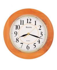 Simply classic. A timeless piece for any room, this wall clock by Bulova features a round, honey-finished wooden frame and bright gold tone bezel. White dial displays easy-to-read numerals and three hands.