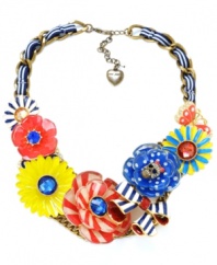 In full bloom. Betsey Johnson's bold statement-making style features a multitude of bright flowers in red, blue, and yellow. Necklace crafted in gold-plated mixed metal with crystal accents, a crystal-encrusted skull, a butterfly charm and a blue and white grosgrain ribbon. Approximate length: 18 inches + 3-inch extender. Approximate drop: 2-1/4 inches.