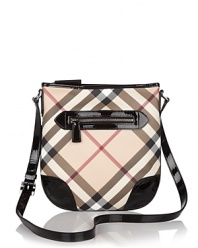 Printed coated canvas crossbody bag with leather trim and adjustable crossbody strap. Front exterior pocket. Top zip closure. Interior zip, cell phone, and additional pockets. Lined.