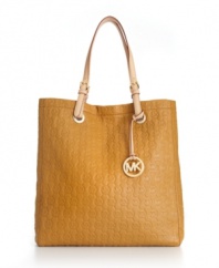 A classic monogram exterior gives this MICHAEL Michael Kors tote a look that will remain classic for seasons to come. This chic design is accented with signature 18K gold hardware and buckle detailed handles.