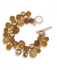 Autumnal allure. Rich golden and amber hues make Carolee's chic cluster bracelet a fashionable option for fall. Made in gold tone mixed metal with a toggle closure, it's embellished with glass accents and sparkling charm details. Approximate length: 8 inches.
