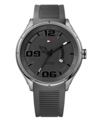 Stylish sport watch that will have you on trend while in the gym, by Tommy Hilfiger. Watch crafted of gray ribbed silicone strap and round stainless steel case. Gray dial features numerals at six, nine and twelve o'clock, applied stick indices, date window at four o'clock, three hands and iconic flag logo at twelve o'clock. Quartz movement. Water resistant to 50 meters. Ten-year limited warranty.