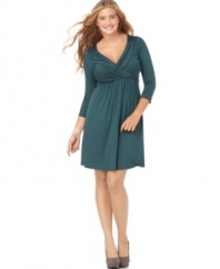 An enhancing crisscrossed front highlights this three-quarter sleeve plus size dress by Soprano.