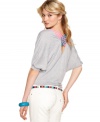 Eyeshadow adds pop to a slouchy-cool top by way of bright, crisscrossed back straps!