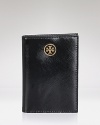 Tory Burch's leather passport holder is a first class travel companion. With slots for your cards and documents, it slips inside your carry on to get organized on-the-go.