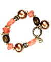 Chocolate and coral spells chic for summer. The acrylic beading on this Jones New York bracelet pairs perfectly with its gold-plated mixed metal accents and logo charm. Bracelet stretches to fit wrist. Approximate length: 8 inches.