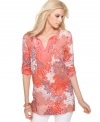 Calvin Klein Jeans' tunic is a beautiful burst of bright colors with its floral-inspired print and solid, coral-hued trim. Totally flawless when worn with skinny white jeans.