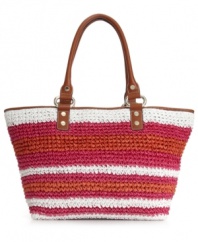 An adorable straw shopper with cheerful stripes. This DKNY style is great for the beach or the city, featuring vibrant colors and luxe leather trim.