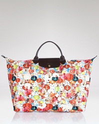 Longchamp's reliable French design goes graphic with this bright tote. Shoulder the color-splashed carryall for a practical pick-me-up--it's sized just right for all your essentials.