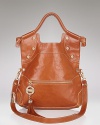 Bright stud detailing in gleaming gold tone and a bold tassel bring star style to Foley + Corinna's sleek leather tote.