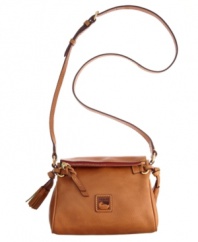 Keep your look classic with this timeless Dooney & Bourke crossbody. An iconic front emblem and refined tassel embodies the designer's quintessential style and grace.