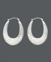 A lady can never go wrong with a classic pair of hoop earrings, especially when they have a twist. Made of 14k white gold, these hoops have an oval shape and feature a graduated twist hoop design. Approximate drop: 1-1/4 inches. Approximate width: 3/4 inch.