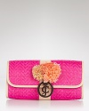 Give looks a rah-rah-resort-inspired spin with this straw clutch from Juicy Couture. Playful pom-poms and a blushy hue make this a cheery vacation companion.