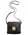 Petite yet perfectly sized for all your essentials, this go-anywhere silhouette from Calvin Klein offers instant versatility. Convenient crossbody strap keeps hands free for easy access to its many pockets and compartments, while glam gold-tone hardware adds instant appeal.