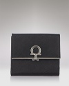 A luxe trifold wallet in textured leather with signature lock detail from Salvatore Ferragamo.