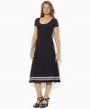 A timeless petite dress is rendered in a soft cotton blend and finished with a flared skirt for a modern silhouette, from Lauren by Ralph Lauren.