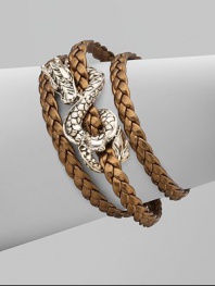 From the Naga Collection. A braid of rich leather wraps the wrist three times while weaving in and out of a curvaceous silver dragon.LeatherSterling silverLength, about 6½Lobster claspMade in Bali
