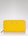 Luxe and lemony. Work the practical side of this season's punched up palette with Marc Jacobs' zip-around wallet.