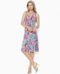 Crafted in sleek matte jersey for a full, floaty silhouette, Lauren by Ralph Lauren's sleeveless empire-waist dress is adorned with a vibrant tropical-inspired print, perfect for warmer months.