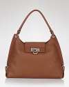 Salvatore Ferragamo's lustrous leather hobo is enhanced by classic and subtle signature hardware.