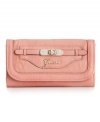 Add a little glam to your life. This sleek clutch style from GUESS features the classic script logo at front with and a sparkling faux turnlock accent.